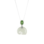 A necklace with a whimsical elephant-shaped pendant carved from pale green nephrite jade, with a green nephrite jade oval at the top, attached to a silver or gold vermeil setting on a silver chain.