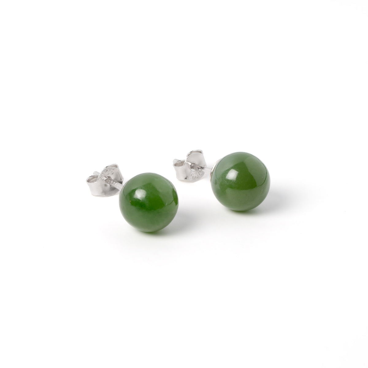 Pair of green jade earrings with silver posts on a white background