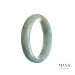 Close-up image of a half-moon shaped, light green Burmese jade bangle, showcasing its genuine natural beauty and intricate craftsmanship.