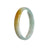A close-up photo of a pale green and yellow jadeite jade bracelet with a half moon design, measuring 58mm in diameter. The bracelet is of authentic Type A quality and is a part of the MAYS™ collection.