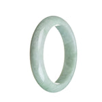 A pale green jadeite bangle with a semi-round shape, measuring 58mm in size.