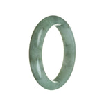 A beautiful green jade bangle bracelet with a semi-round shape, measuring 60mm in size. This genuine Grade A jade bracelet from MAYS is a traditional and timeless piece of jewelry.