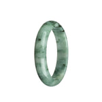 A close-up of a beautiful green and white jade bangle bracelet with a dark green pattern, shaped like a half moon.