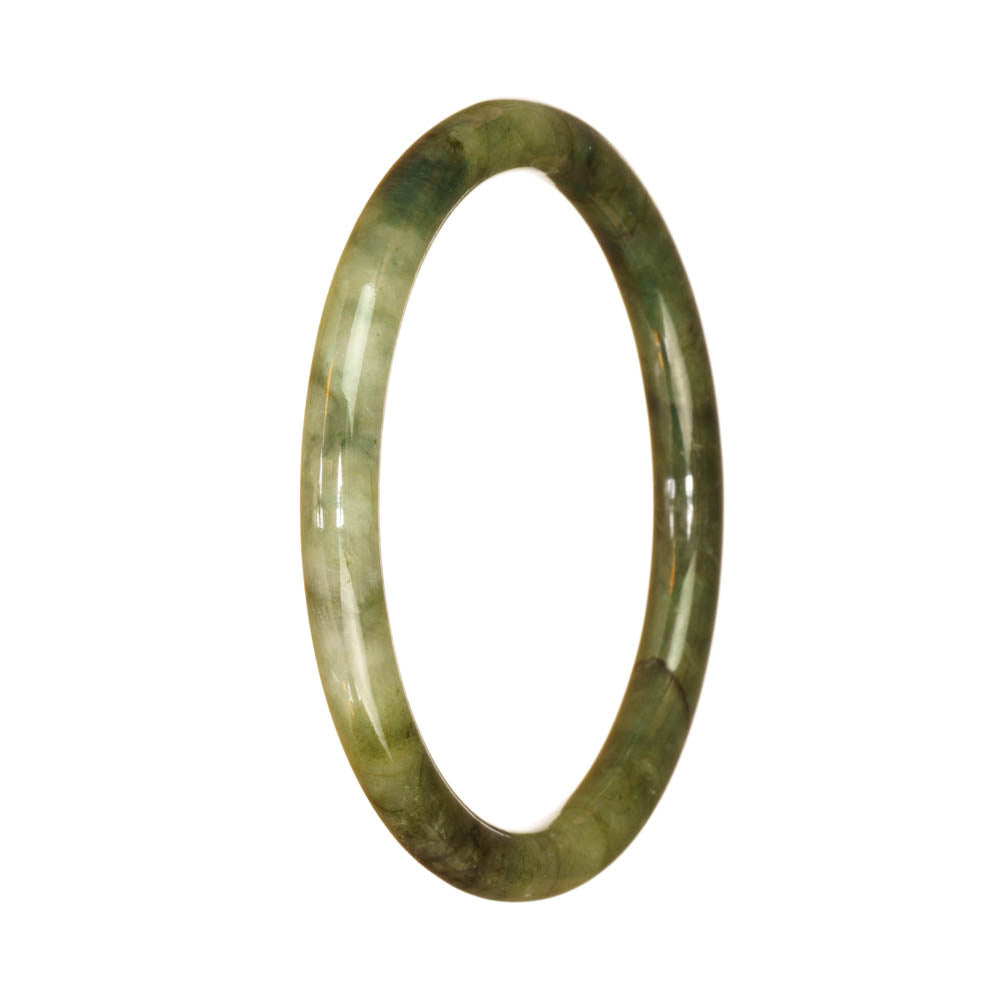 A small, round jade bracelet with a traditional green pattern.