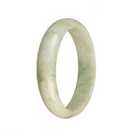 A stunning traditional jade bangle in white with apple green patterns, featuring a half moon shape. A beautiful and authentic piece from MAYS GEMS.