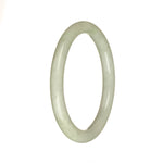 A round jade bangle bracelet with greyish white and light green patterns.