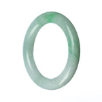 A round, untreated green traditional jade bangle bracelet measuring 58mm in diameter. Made by MAYS.