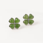Green four-leaf clover earrings on a white background