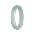 A half-moon shaped, icy apple green Burmese jade bracelet with a smooth surface.