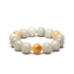 A bracelet featuring round beads in shades of white and yellow, representing a mix of jade and topaz.