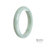 A close-up of a pale green jade bangle, shaped like a half moon, with a smooth and polished surface. The bangle has a rich and authentic appearance, showcasing the natural beauty of the high-quality jade.