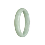 A close-up photo of a light green jadeite bracelet in the shape of a half moon. The bracelet is made with high-quality grade A jadeite and measures 56mm in diameter. It has a smooth and polished surface, showcasing the natural beauty of the jadeite stone. The bracelet is from MAYS GEMS, a reputable jewelry brand.