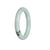 A round jade bangle in authentic Type A green with lavender hues, measuring 51mm in circumference. Sold by MAYS GEMS.