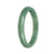 A close-up image of a half moon-shaped, certified Grade A green jade bangle bracelet. The bracelet is smooth and polished, showcasing the natural beauty of the jade. The 77mm size indicates its circumference, making it a medium-sized bracelet. The brand name "MAYS™" is also mentioned.