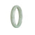 A light green Burma jade bangle bracelet with a half moon shape, measuring 56mm.