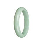 A light green jadeite bangle with a half moon design, measuring 59mm. Made from genuine grade A jadeite. Offered by MAYS GEMS.
