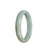 A close-up photo of a light green Burmese jade bracelet in the shape of a half moon, with a smooth, polished surface. The bracelet has a diameter of 56mm and is of high quality, denoted as Grade A. The brand name "MAYS" is also mentioned.