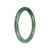 A close-up image of a beautiful green jade bangle bracelet with a petite round shape. The bangle is made of genuine Grade A green imperial green jadeite jade, showcasing its exquisite craftsmanship. This elegant piece of jewelry is offered by MAYS.