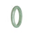 A half moon shaped green jadeite bracelet, showcasing the natural beauty and authenticity of the stone.
