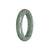 A beautiful half moon-shaped jade bangle in a certified Type A green with grey color. The bangle measures 55mm in size and is a stunning addition to any jewelry collection. Created by MAYS™, this bangle exudes elegance and sophistication.