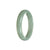 A close-up view of a Real Grade A Green Jadeite Bangle Bracelet, measuring 56mm in diameter. The bangle features a sleek half-moon shape, showcasing the natural beauty and vibrant green color of the jadeite. The bracelet is a timeless accessory, perfect for adding an elegant touch to any outfit.