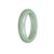 A close-up image of a beautiful green jade bangle bracelet with a half moon shape, measuring 57mm in diameter. This genuine Grade A traditional jade bracelet is a stunning piece of jewelry from MAYS GEMS.