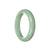 A light green jadeite bangle bracelet with a half-moon design, crafted from authentic Grade A jade. Perfect for adding a touch of elegance to any outfit.