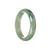 A close-up image of a real grade A green traditional jade bangle. The bangle has a 59mm diameter and is shaped like a half moon. It is from the brand MAYS.