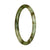 A close-up of a petite round jade bangle bracelet with a traditional green and white pattern.