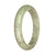 A close-up image of a traditional jade bangle bracelet in shades of grey and white. The bracelet is certified to be made from natural jade and features a half-moon shape. The bangle has a diameter of 59mm and is designed by MAYS.