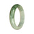 A half-moon shaped, 54mm diameter bangle bracelet made of certified untreated white and light green patterned Burma Jade.