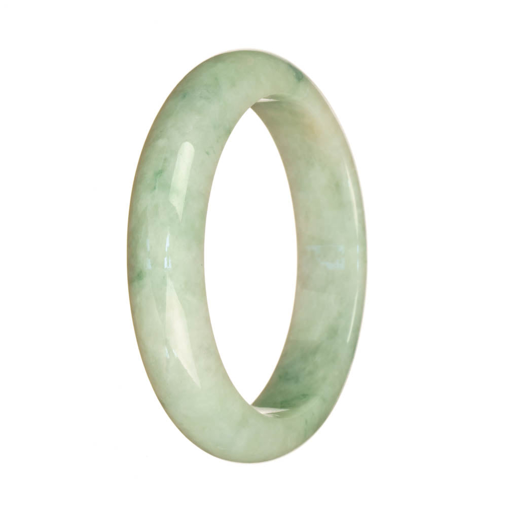 A half moon-shaped jade bangle with a natural white color and intricate green pattern.