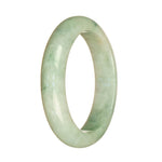 A half moon-shaped jade bangle with a natural white color and intricate green pattern.