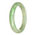 A stunning half moon jade bracelet in authentic untreated pale green with emerald green hues from Burma.