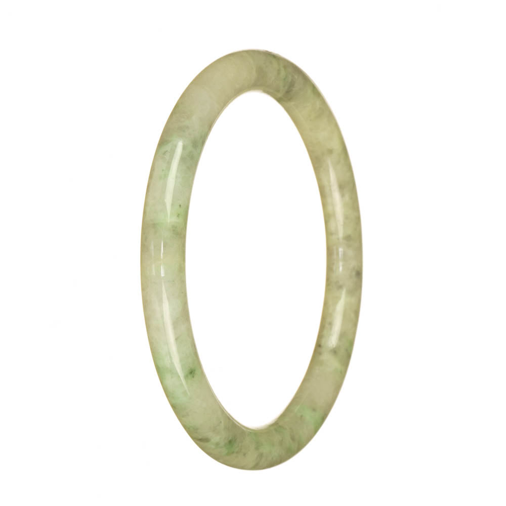 A close-up of a petite round bangle bracelet made of genuine Type A pale green pattern Burma Jade, featuring intricate details and a smooth finish.