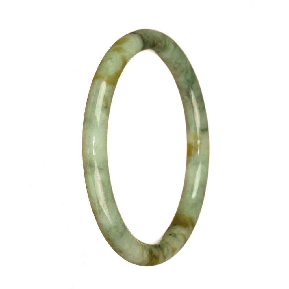 A small, round Burmese jade bangle in a light green color with a beautiful pattern.