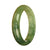 A close-up image of a traditional jade bracelet with a green pattern. The bracelet is shaped like a half moon and measures 58mm in size. It is made from genuine grade A jade and is sold by MAYS GEMS.
