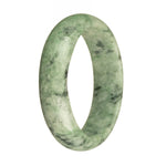 A close-up of a beautiful jade bangle bracelet with natural green color, dark green patterns, and apple green spots. The bracelet is a half moon shape and measures 63mm in diameter.