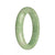 A close-up image of a stunning apple green jadeite bracelet in the shape of a half moon. The bracelet is made of genuine, untreated jadeite and measures 58mm in diameter. It is a beautiful piece of jewelry from the MAYS™ collection.
