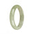 A light green jadeite jade bangle bracelet with a half moon shape, measuring 55mm in diameter.