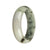 A stunning half moon shaped bracelet made of genuine untreated green and white with dark green patterns Burma Jade.
