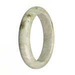 A close-up image of a beautiful grey jade bangle bracelet with intricate brown patterns, shaped like a half moon.