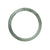 A close-up image of a real untreated green grey traditional jade bracelet. The bracelet is semi-round in shape and measures 55mm in diameter. It is a product of MAYS™.
