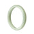 A pale green traditional jade bangle bracelet with a half moon shape, made from real natural jade.