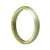 A half-moon shaped, certified natural brownish green jade bangle bracelet by MAYS™, measuring 58mm in diameter.
