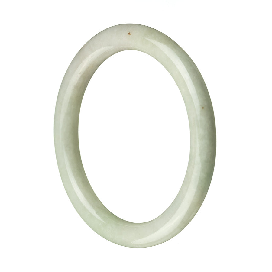 A close-up photo of an untreated pale green lavender jadeite bracelet. The bracelet is round and has a diameter of 60mm. The jadeite has an authentic and natural appearance, showcasing its unique color and texture. Perfect for adding a touch of elegance to any outfit. Sold by MAYS GEMS.