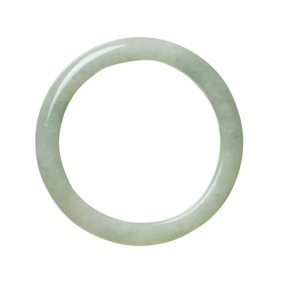 A close-up photo of a real untreated pale green traditional jade bracelet. The bracelet is semi-round in shape and measures 63mm in diameter. It features a smooth and polished surface, showcasing the natural beauty of the jade stone.
