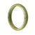 A beautiful green jade bracelet in a half moon shape, showcasing its authentic natural beauty.