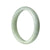 An elegant, pale green jade bracelet with a half moon design, handmade with authentic Grade A jade.