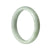 A light green Burmese jade bangle bracelet with a semi-round shape, measuring 57mm in size. Perfect for adding a touch of elegance to any outfit.